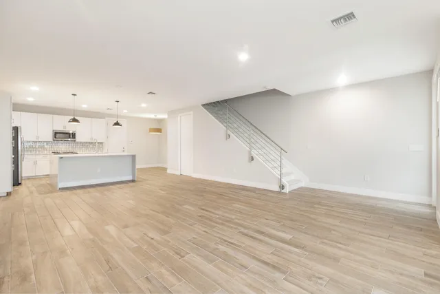 a view of a kitchen with a sink and a refrigerator