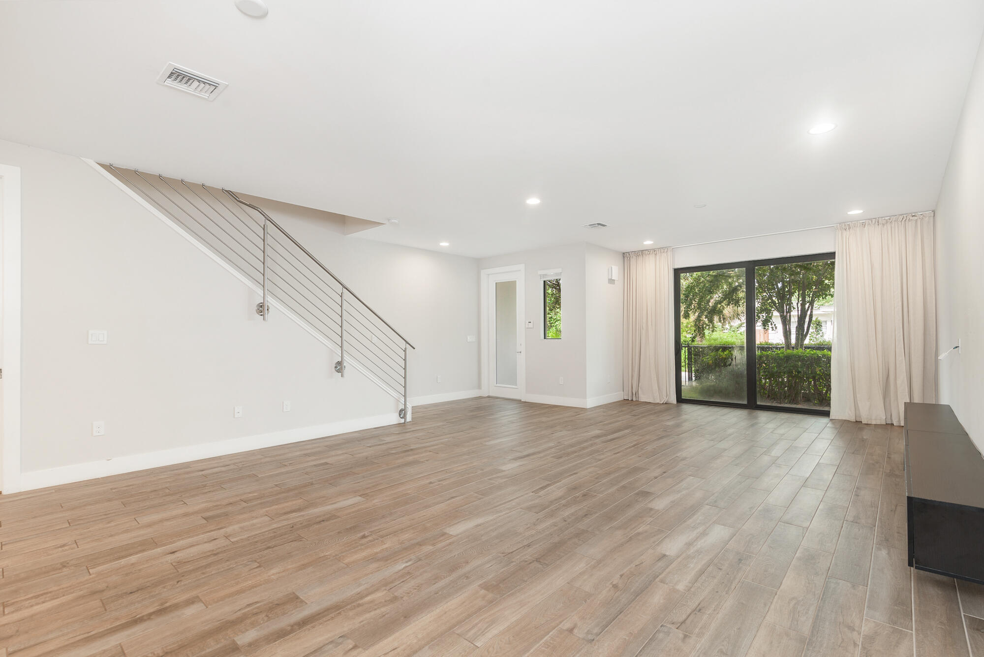 3764 Lambert Avenue West Palm Beach, FL 33405 - Photo 6 of 25 a view of an empty room with wooden floor and entryway