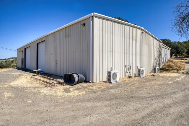 a view of an empty room with wooden fence
