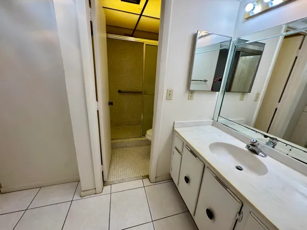 a bathroom with a double vanity sink and mirror