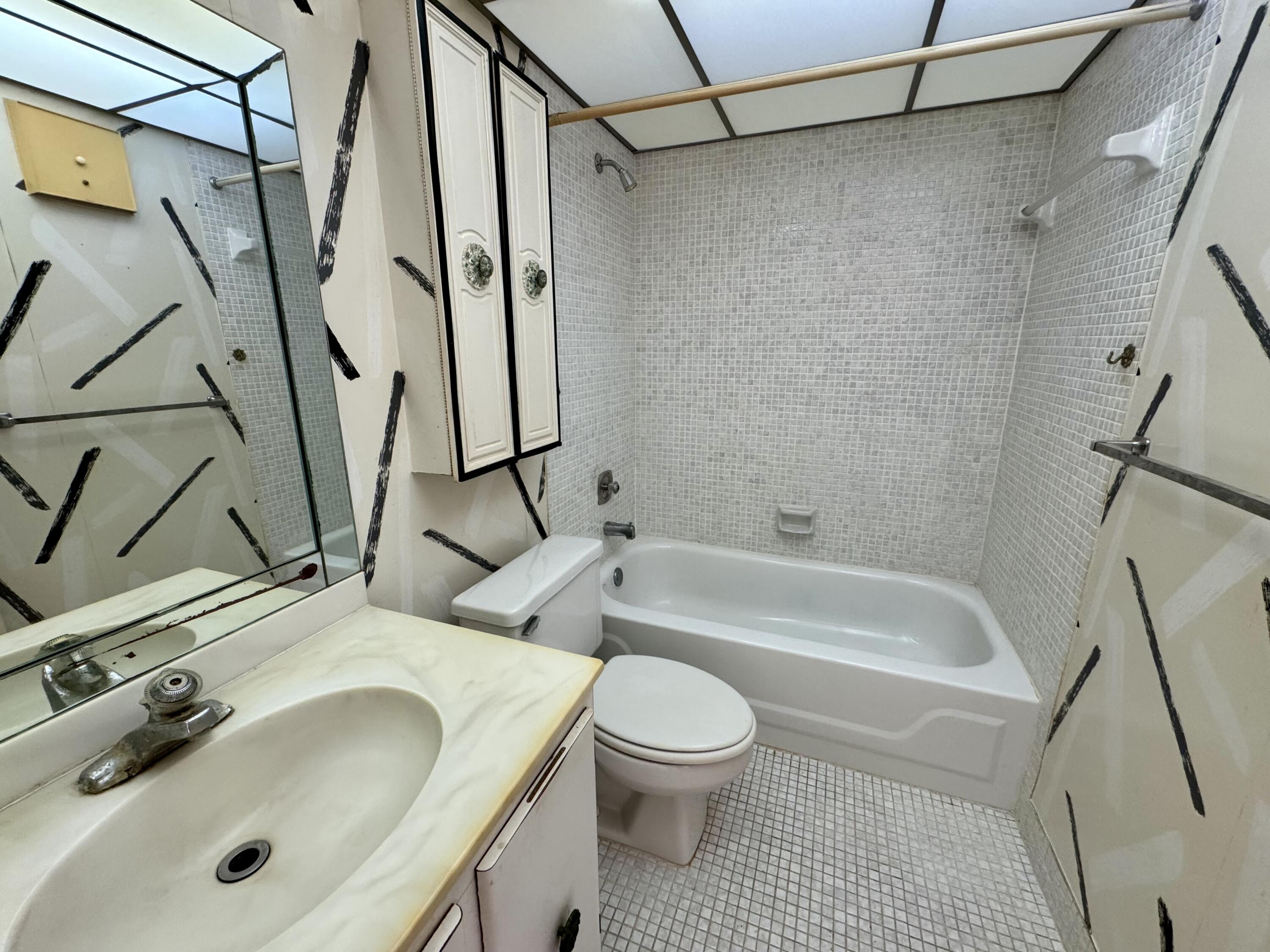 8050 West McNab Road, Unit 320 Tamarac, FL 33321 - Photo 18 of 24 a bathroom with a sink a toilet and shower