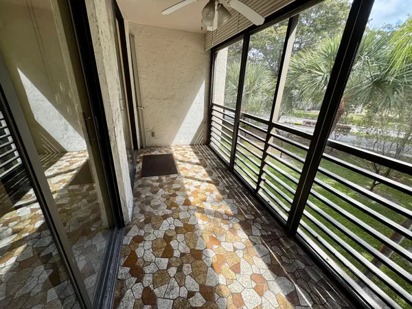 a view of a balcony with wooden floor