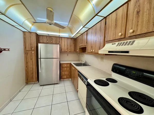 a kitchen with a refrigerator and a sink