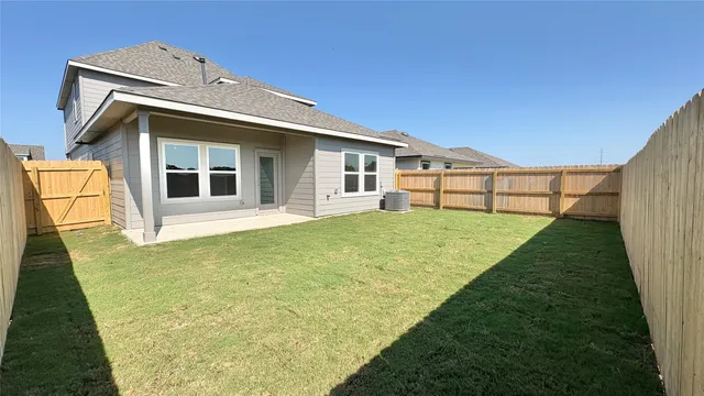 a view of a house with pool and wooden fence