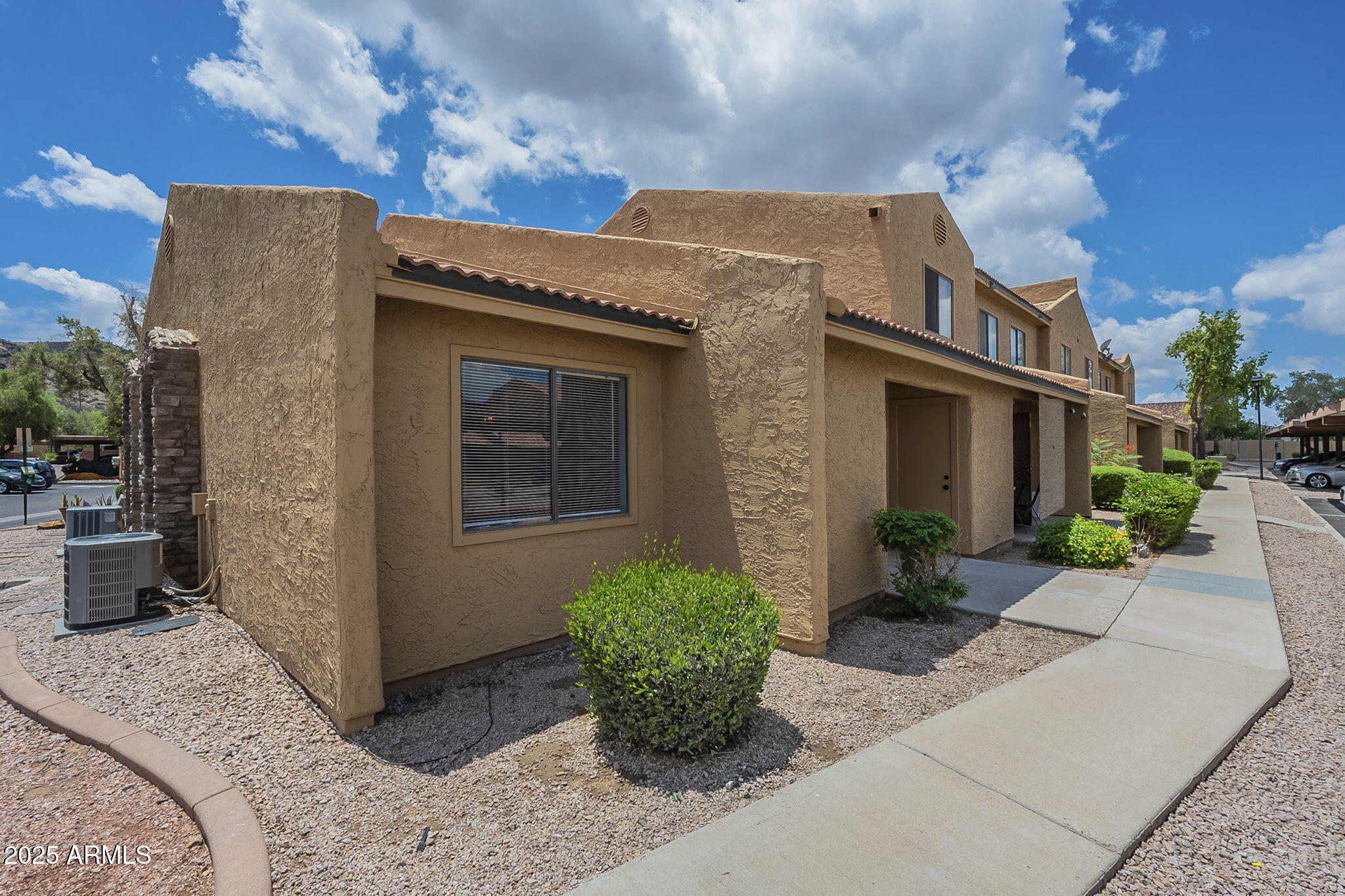 3511 East Baseline Road, Unit 1033 Phoenix, AZ 85042 - Photo 1 of 27 a front view of a house with potted plants