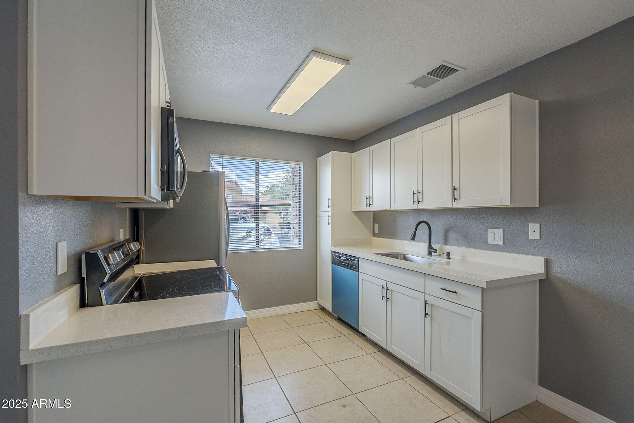 3511 East Baseline Road, Unit 1033 Phoenix, AZ 85042 - Photo 12 of 27 a kitchen that has a sink and a stove in it