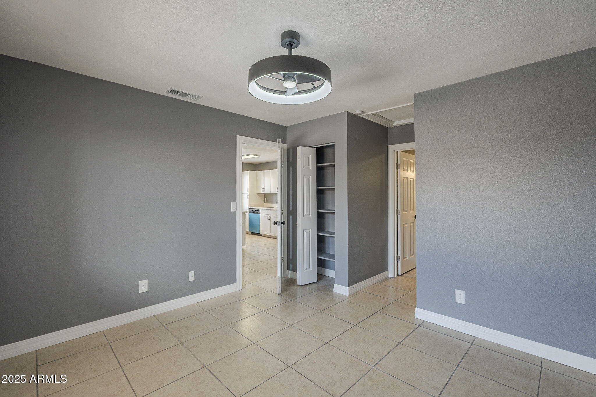 3511 East Baseline Road, Unit 1033 Phoenix, AZ 85042 - Photo 19 of 27 an empty room with closet and windows