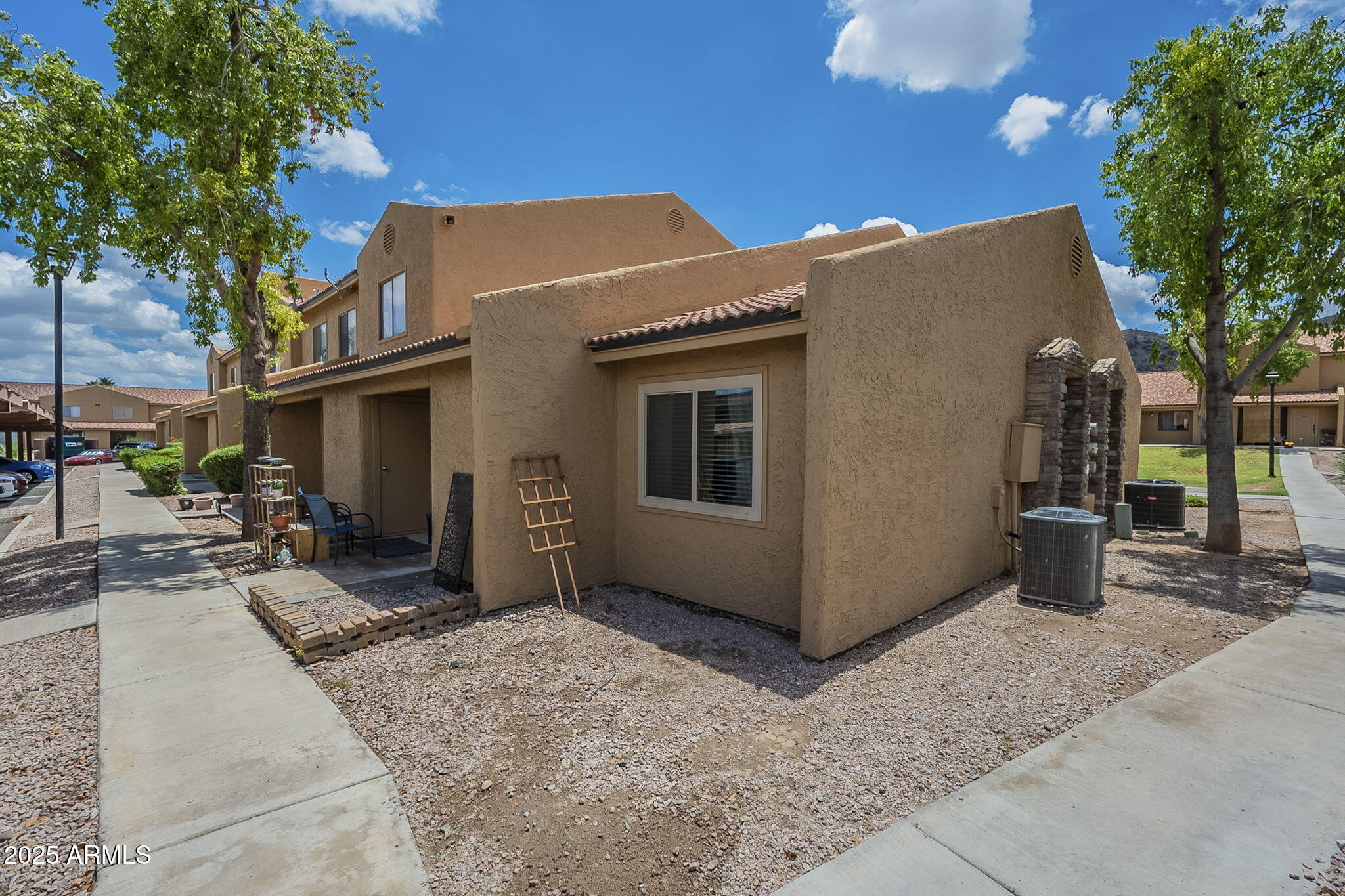 3511 East Baseline Road, Unit 1033 Phoenix, AZ 85042 - Photo 2 of 27 a view of a house with a yard