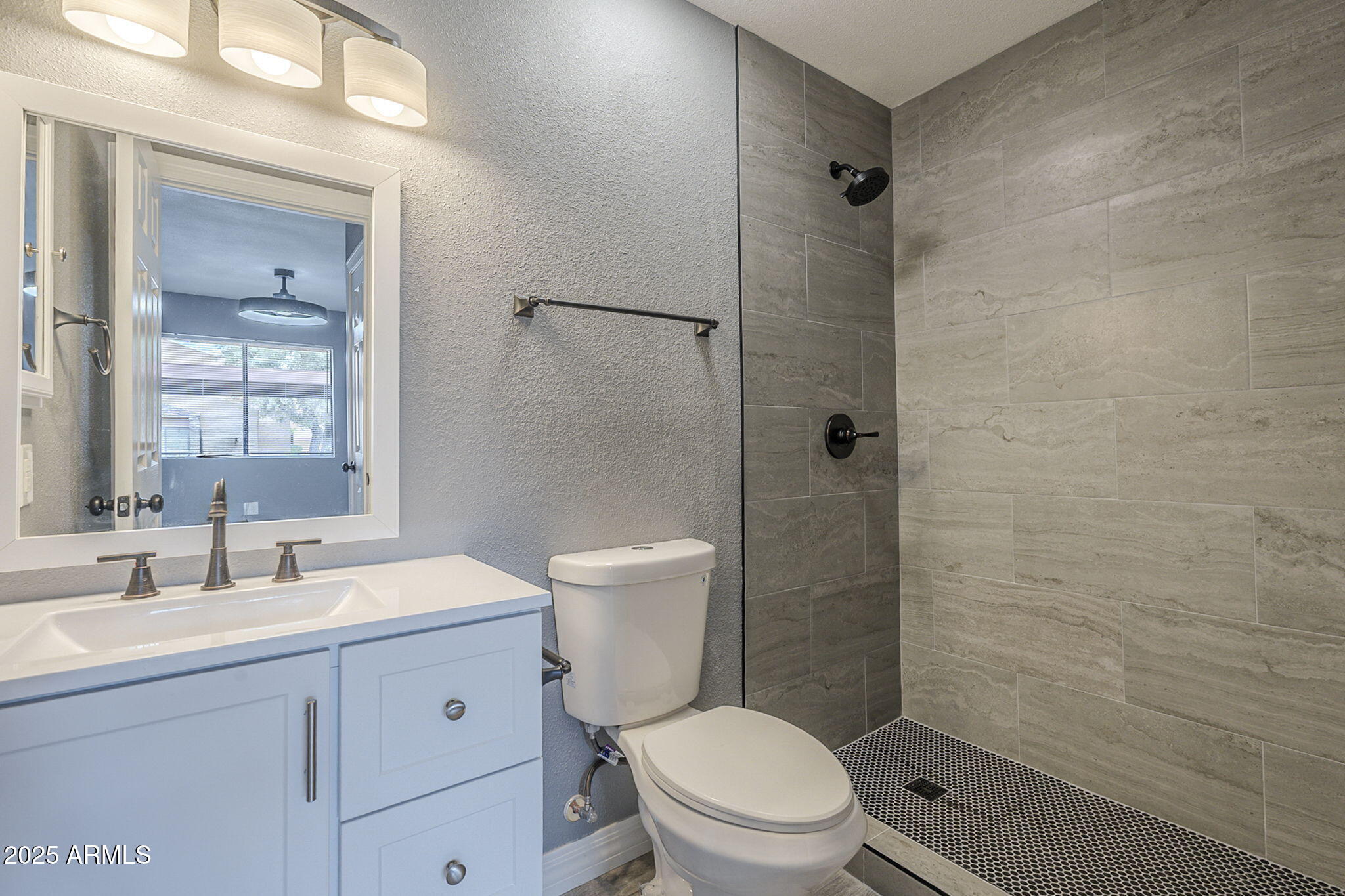 3511 East Baseline Road, Unit 1033 Phoenix, AZ 85042 - Photo 24 of 27 a bathroom with a toilet a sink a shower and vanity