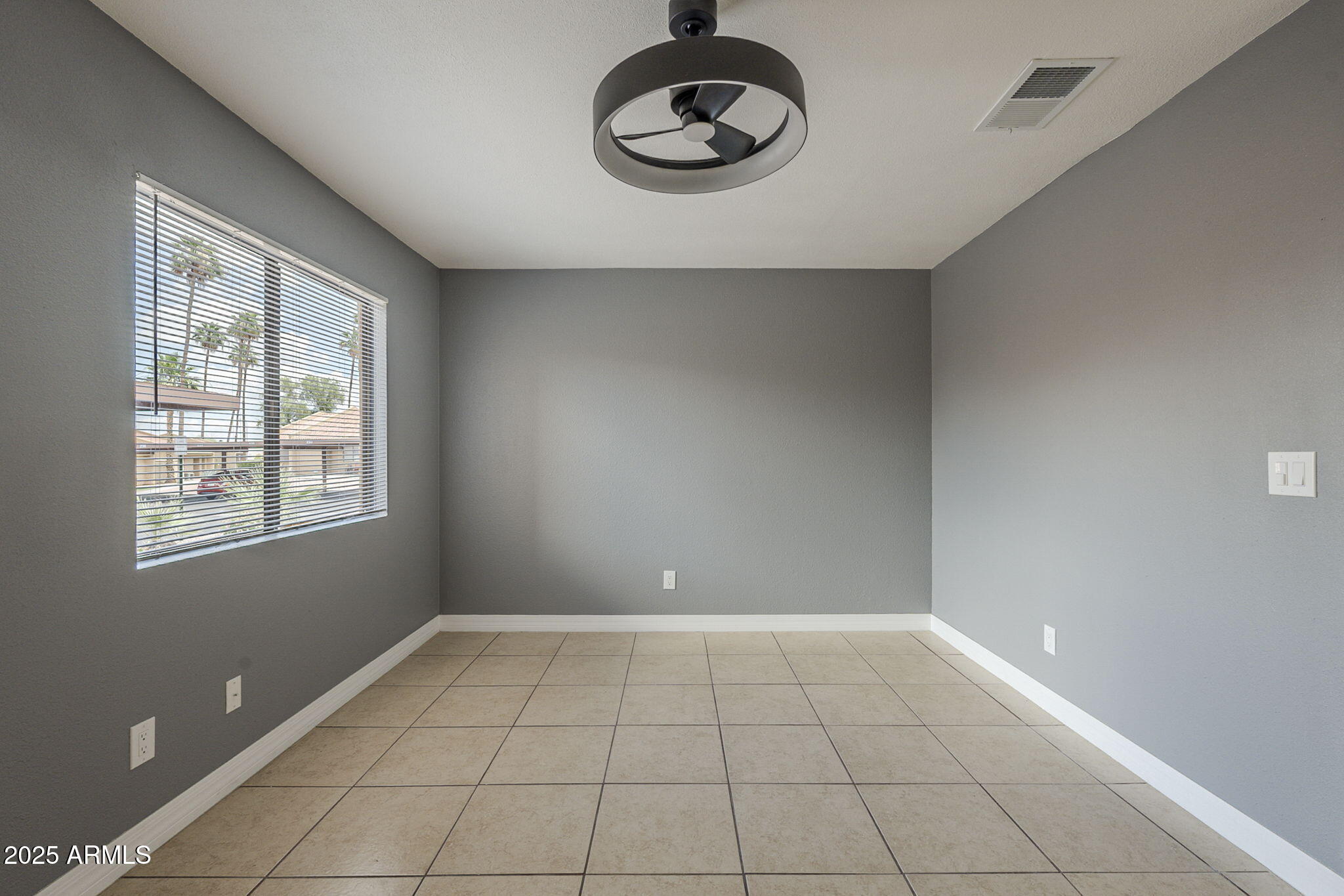 3511 East Baseline Road, Unit 1033 Phoenix, AZ 85042 - Photo 8 of 27 a view of an empty room with a window and wooden floor