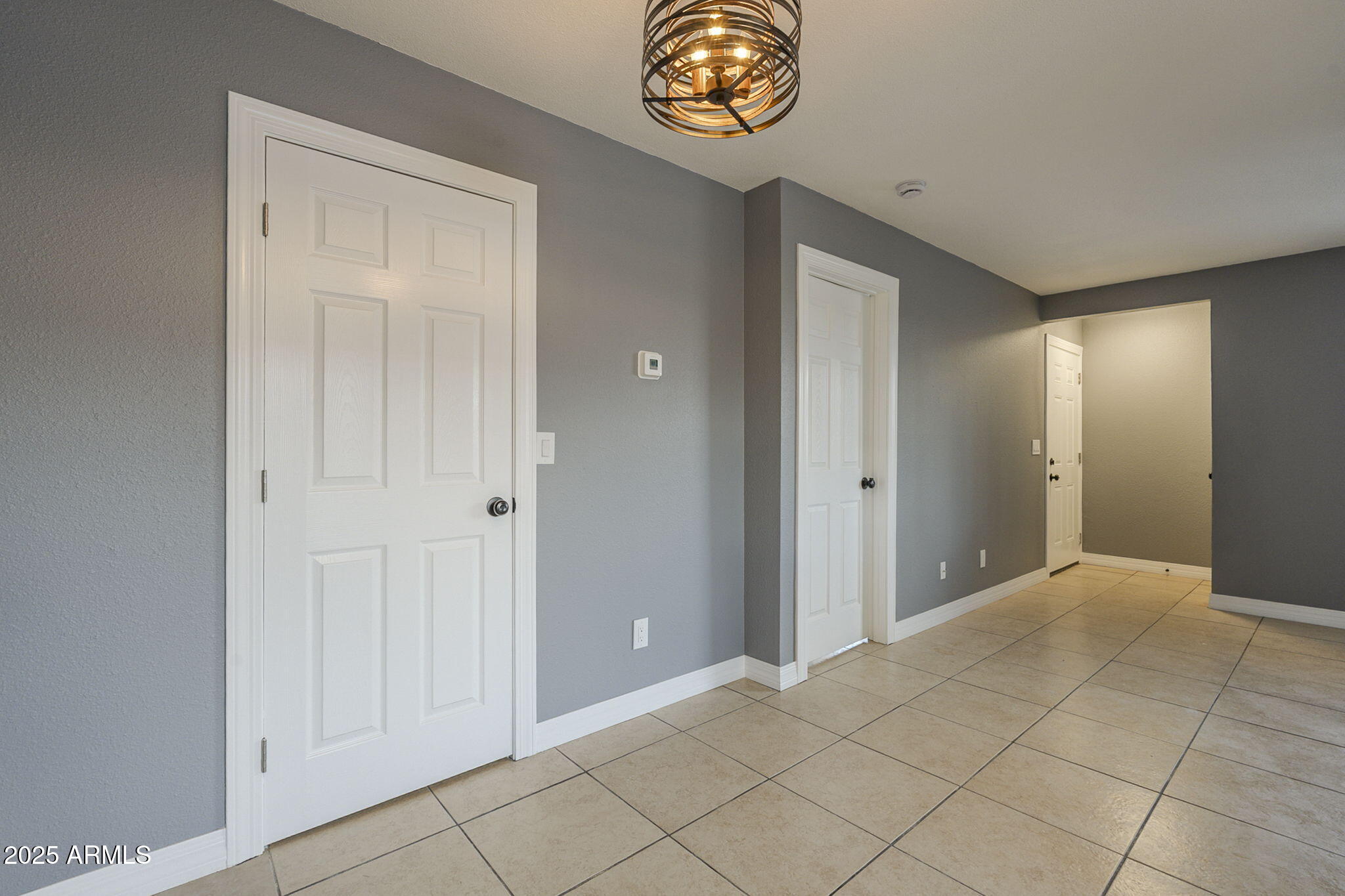 3511 East Baseline Road, Unit 1033 Phoenix, AZ 85042 - Photo 10 of 27 a view of an entryway with a chandelier