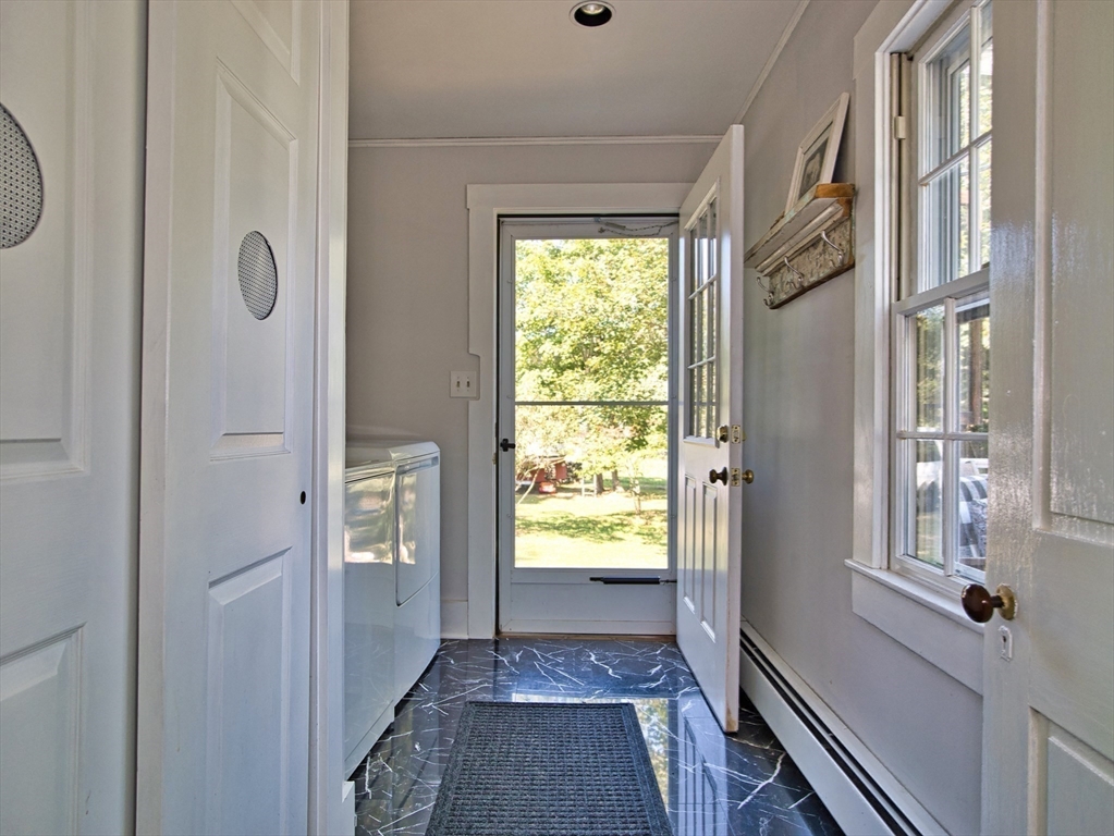 56 Maple Avenue Little Compton, RI 02837 - Photo 15 of 33 a view of a hallway with wooden floor and windows