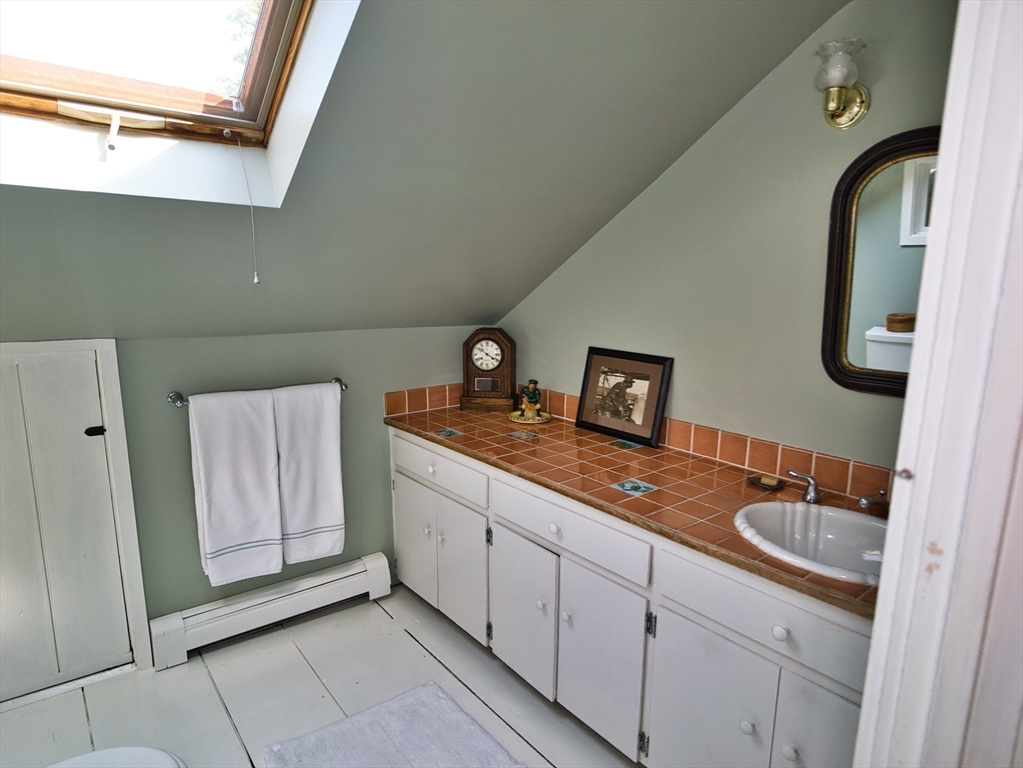 56 Maple Avenue Little Compton, RI 02837 - Photo 25 of 33 a bathroom with a sink and mirror