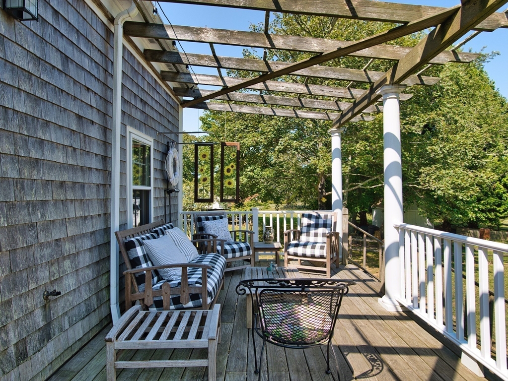 56 Maple Avenue Little Compton, RI 02837 - Photo 26 of 33 a view of balcony with wooden floor and outdoor seating