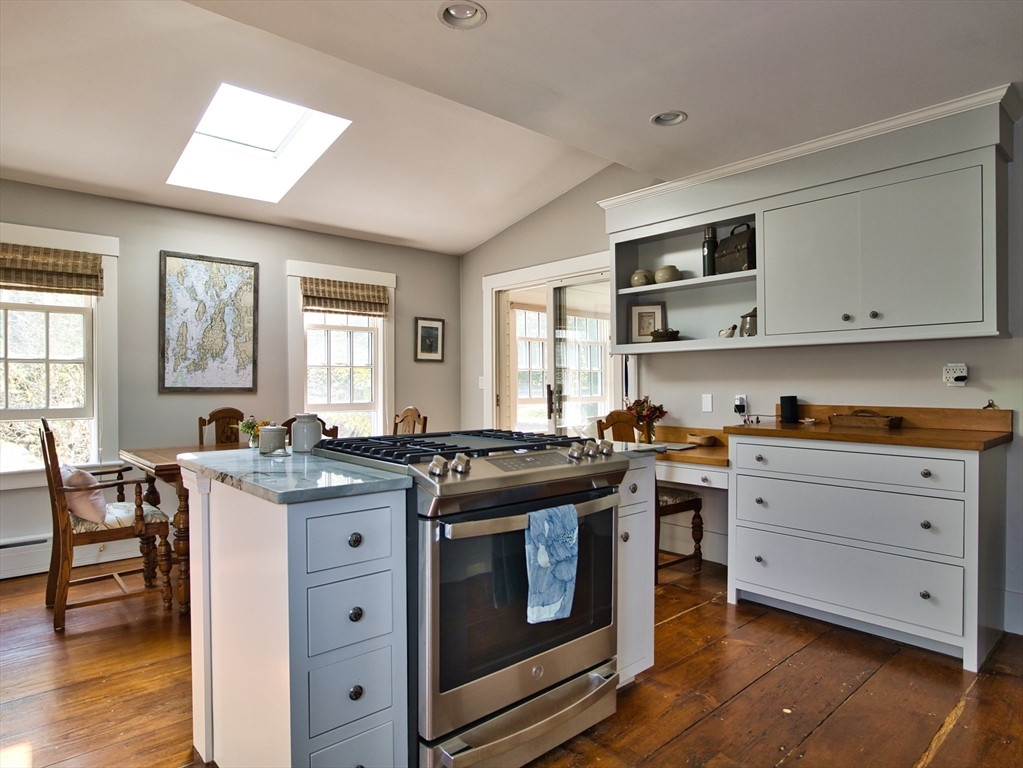 56 Maple Avenue Little Compton, RI 02837 - Photo 3 of 33 a kitchen with stainless steel appliances granite countertop a stove and cabinets