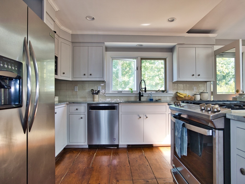 56 Maple Avenue Little Compton, RI 02837 - Photo 5 of 33 a kitchen with granite countertop stainless steel appliances a sink window and cabinets