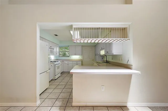 a room with a sink a table and chairs