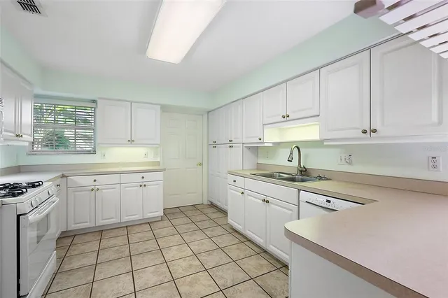 a kitchen with a sink cabinets and window