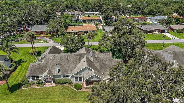 an aerial view of a house with a yard and lake view