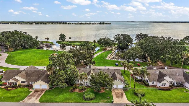 a view of a lake with houses in the back