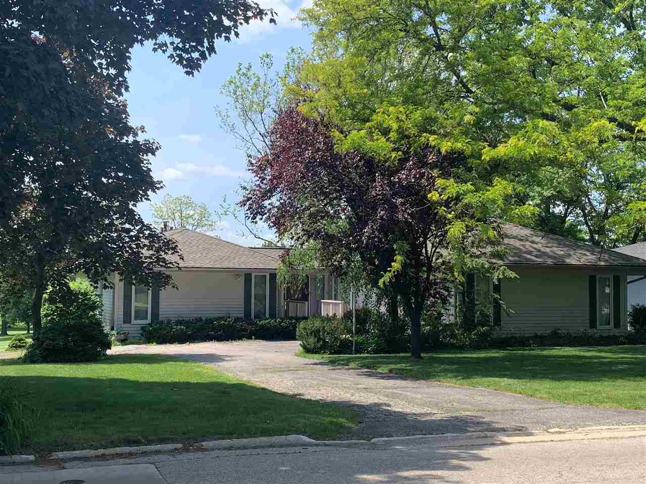 1108 Roxbury Road Rockford, IL 61107 - Photo 1 of 2 a front view of a house with a yard and garage