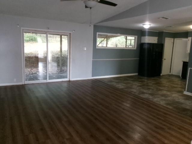 9146 Kingston Road Shreveport, LA 71118 - Photo 5 of 14 an empty room with wooden floor and windows