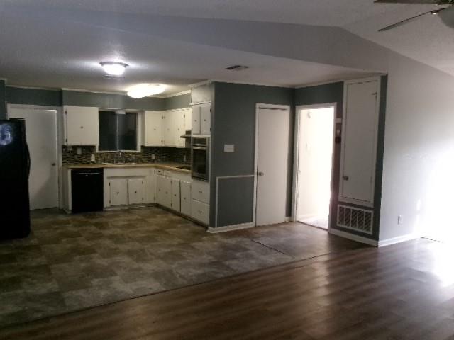 9146 Kingston Road Shreveport, LA 71118 - Photo 6 of 14 a kitchen with granite countertop a refrigerator and a stove top oven