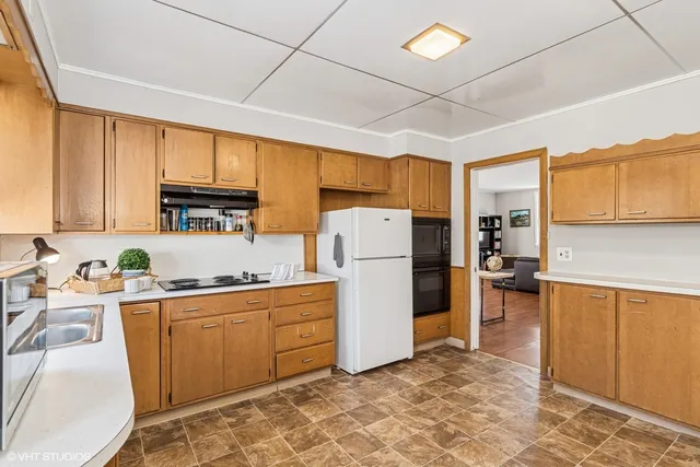 a kitchen with a sink appliances and cabinets