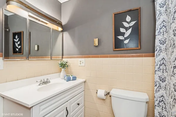 a bathroom with a sink a toilet and mirror