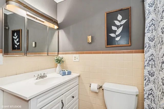 a bathroom with a sink a toilet and mirror