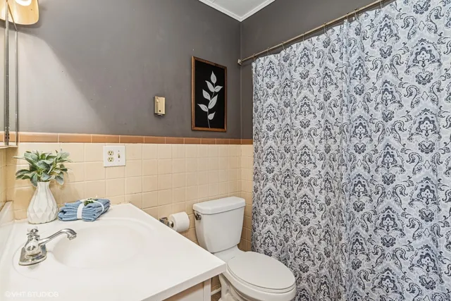 a bathroom with a toilet and a sink