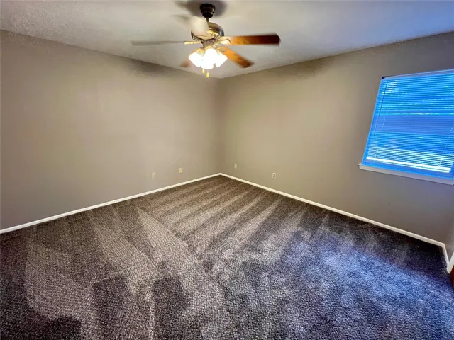 a view of room with window and ceiling fan