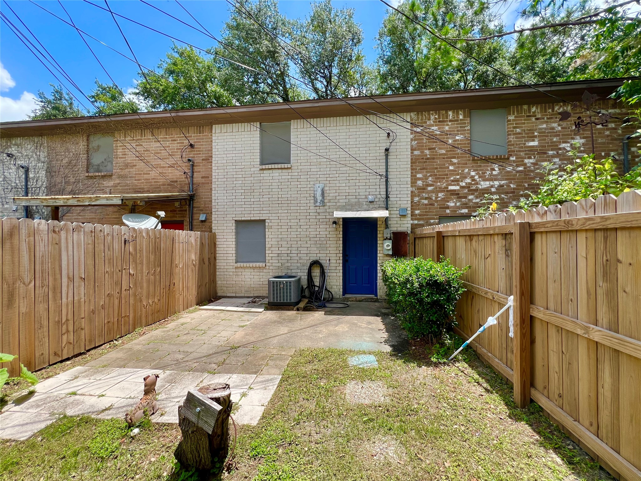 1039-1045 North Chenango Street Angleton, TX 77515 - Photo 15 of 17 a backyard of a house with plants and a tree