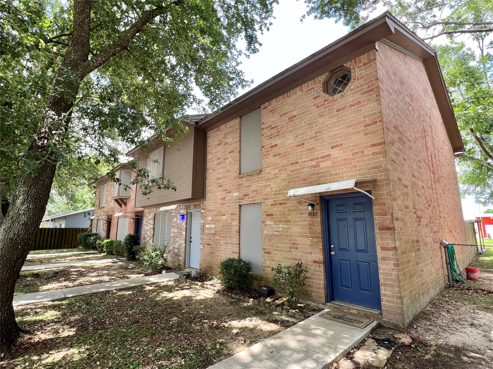 1039-1045 North Chenango Street Angleton, TX 77515 - Photo 16 of 17 a front view of a house with a yard