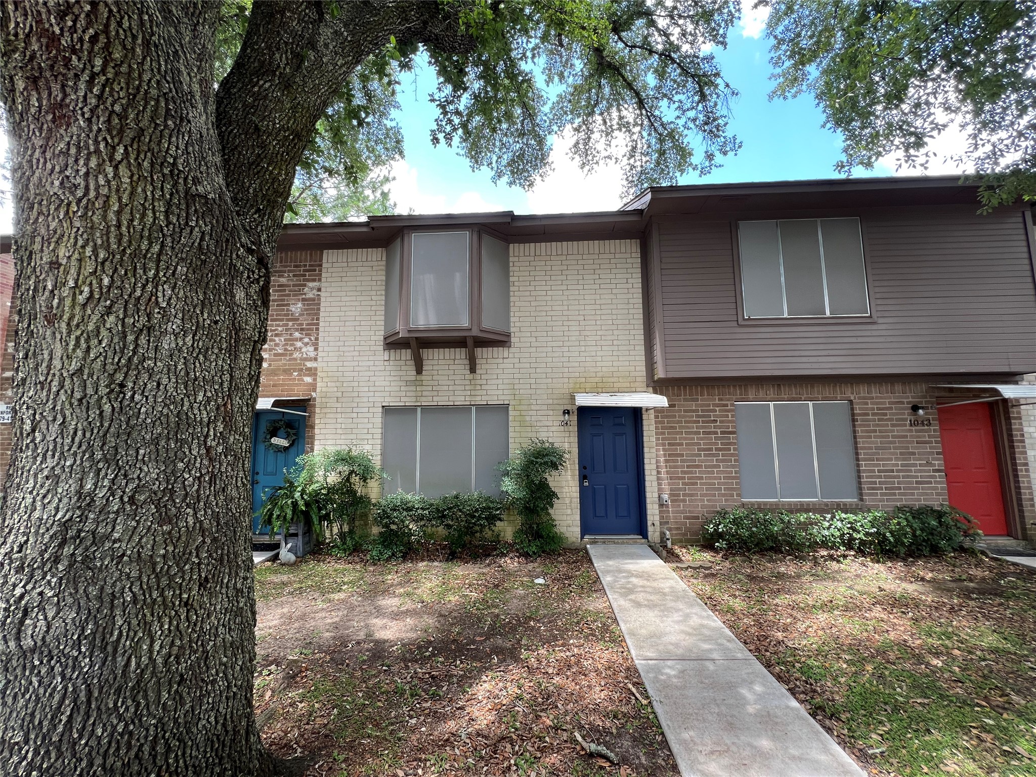 1039-1045 North Chenango Street Angleton, TX 77515 - Photo 4 of 17 a front view of a house with a yard