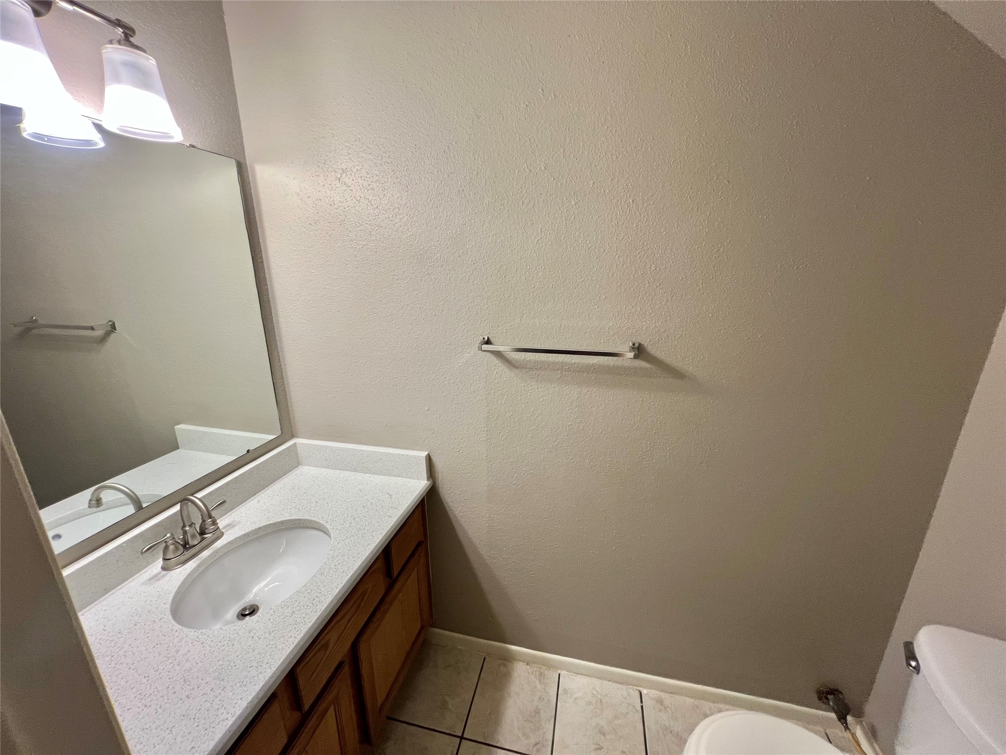 1039-1045 North Chenango Street Angleton, TX 77515 - Photo 10 of 17 a bathroom with a sink and a toilet
