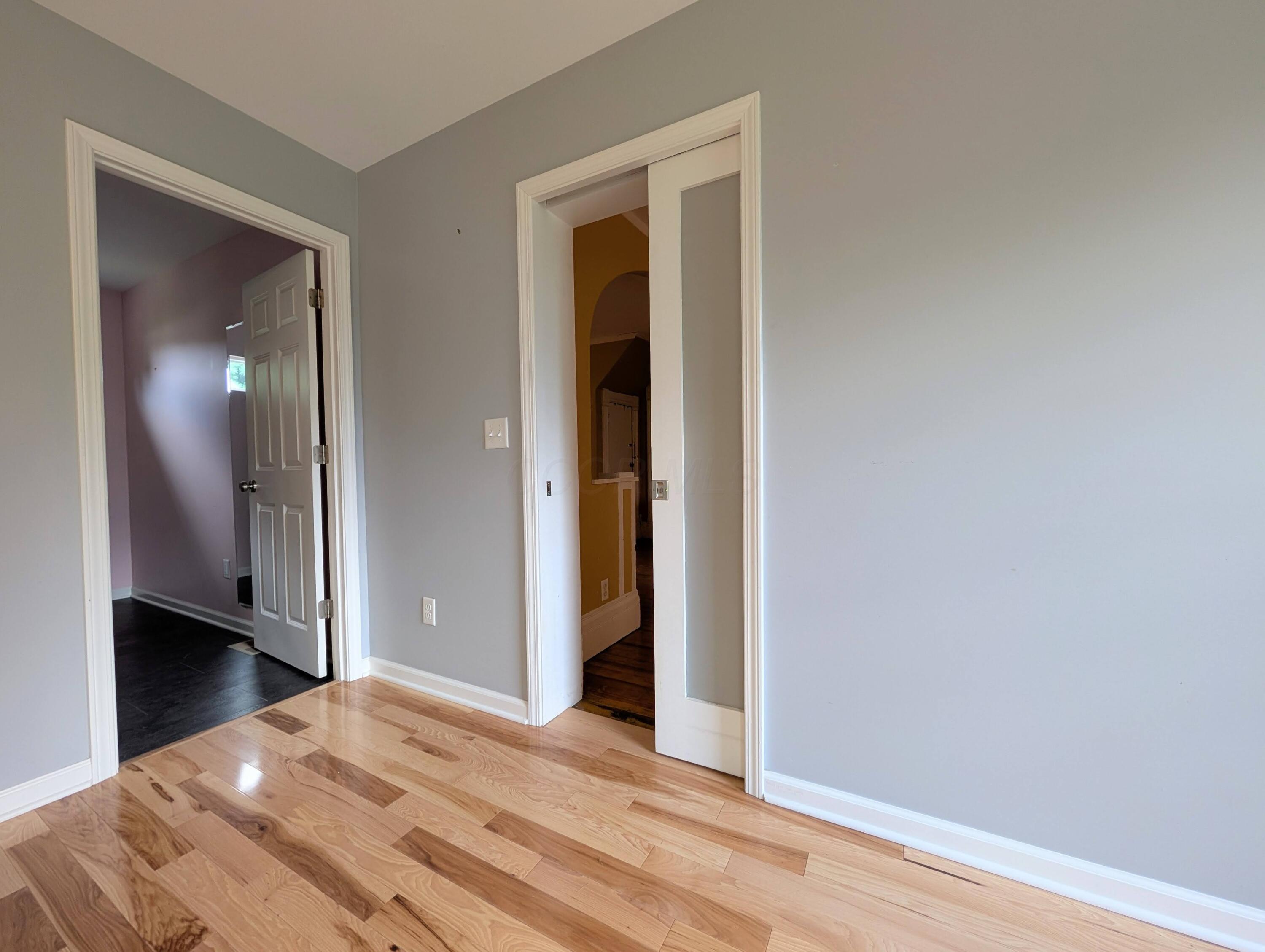 3340 Stringtown Road Northeast Lancaster, OH 43130 - Photo 10 of 27 Newer wood floors and smoked glass pocket door.