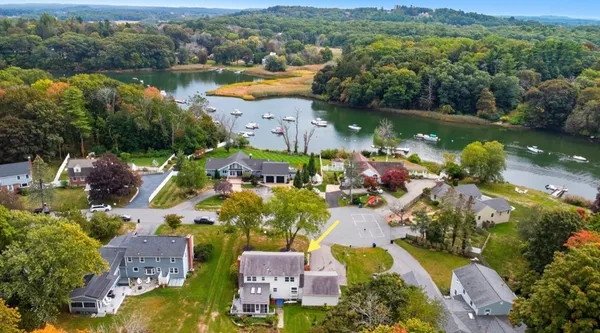 an aerial view of lake residential house with swimming pool and green space