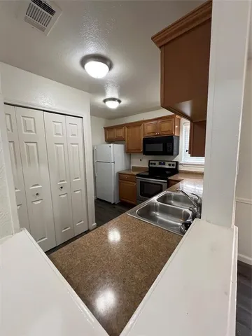 a kitchen with a refrigerator and a stove