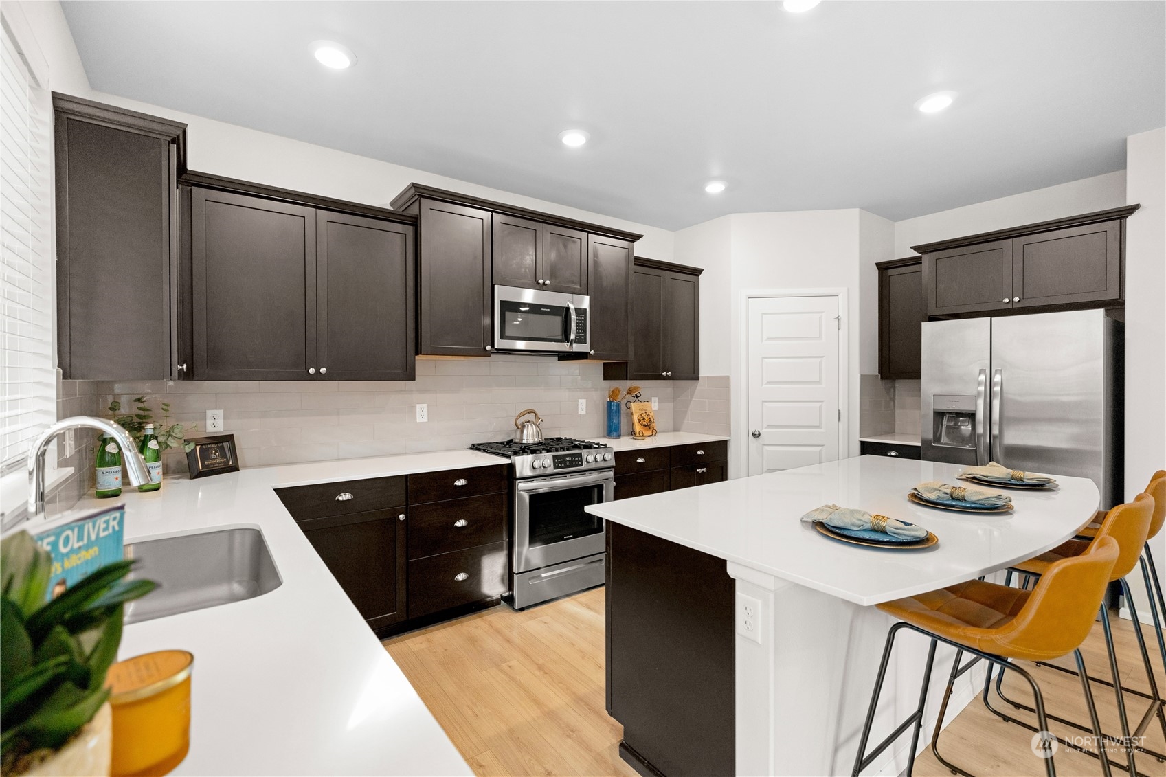 1341 Cascade Street Sultan, WA 98294 - Photo 8 of 39 a kitchen with stainless steel appliances granite countertop a sink dishwasher stove refrigerator and couches with wooden floor