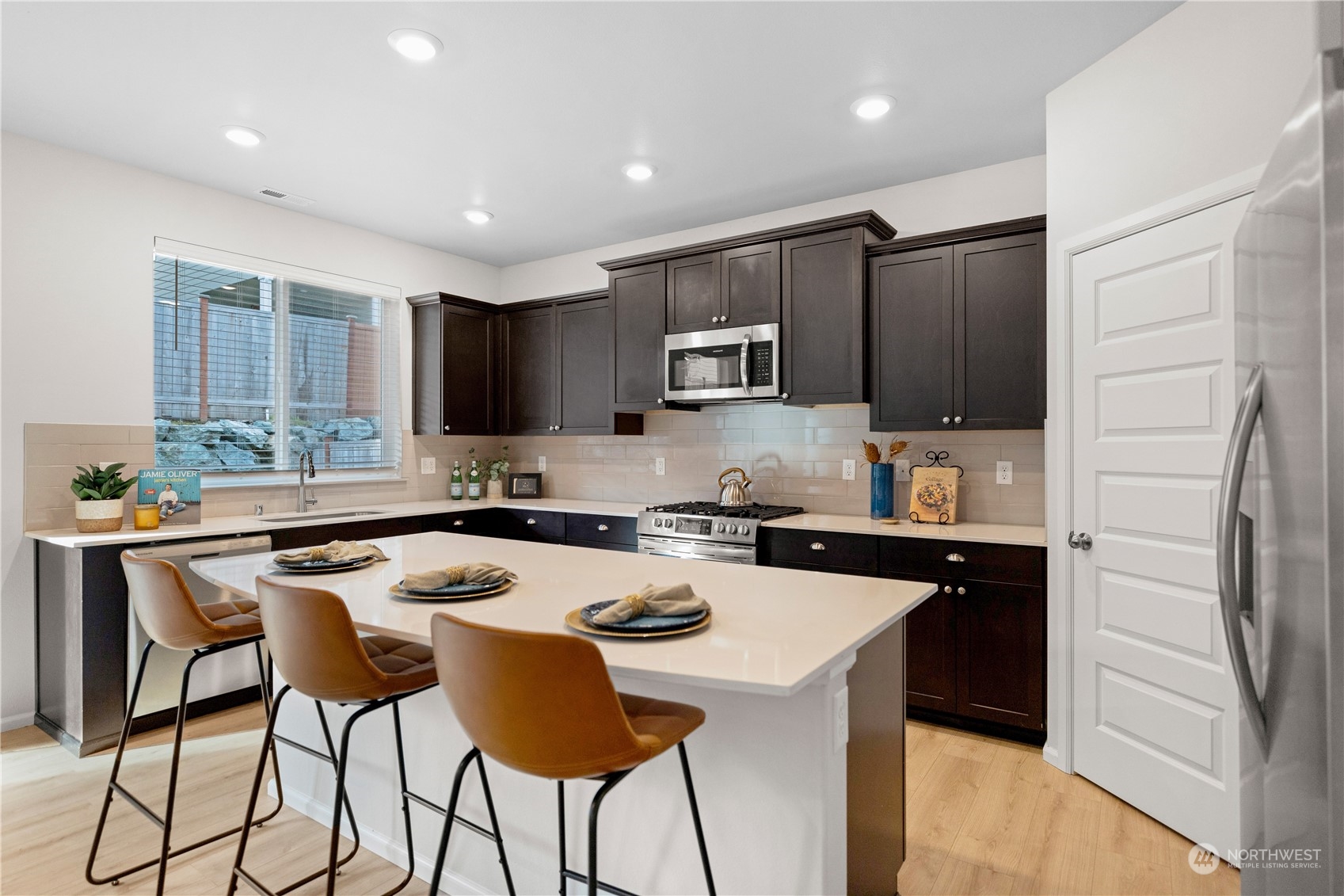 1341 Cascade Street Sultan, WA 98294 - Photo 10 of 39 a kitchen with a sink a stove a refrigerator a center island and chairs