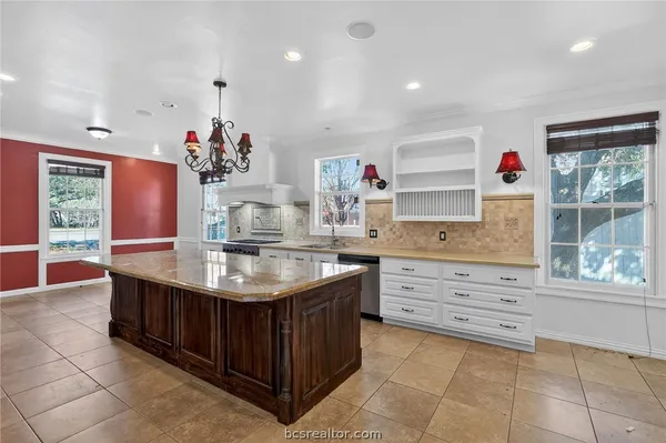 a kitchen with a sink stove and cabinets
