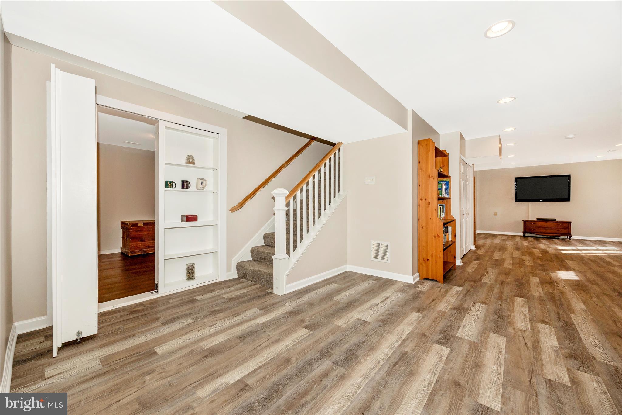 3340 Florence Road Woodbine, MD 21797 - Photo 33 of 61 a view of a livingroom with wooden floor and a flat screen tv