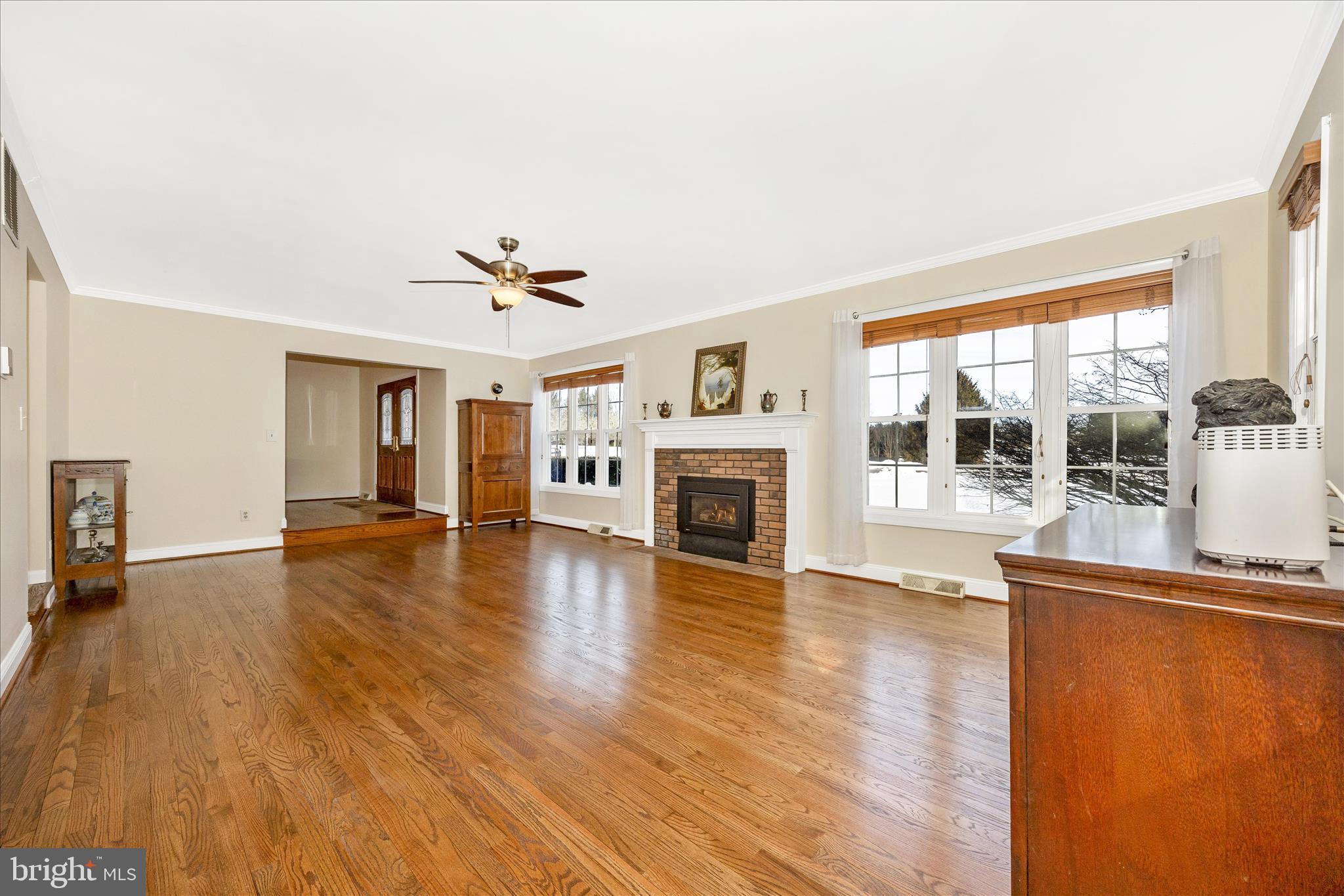 3340 Florence Road Woodbine, MD 21797 - Photo 6 of 61 a view of a livingroom with furniture a ceiling fan and wooden floor