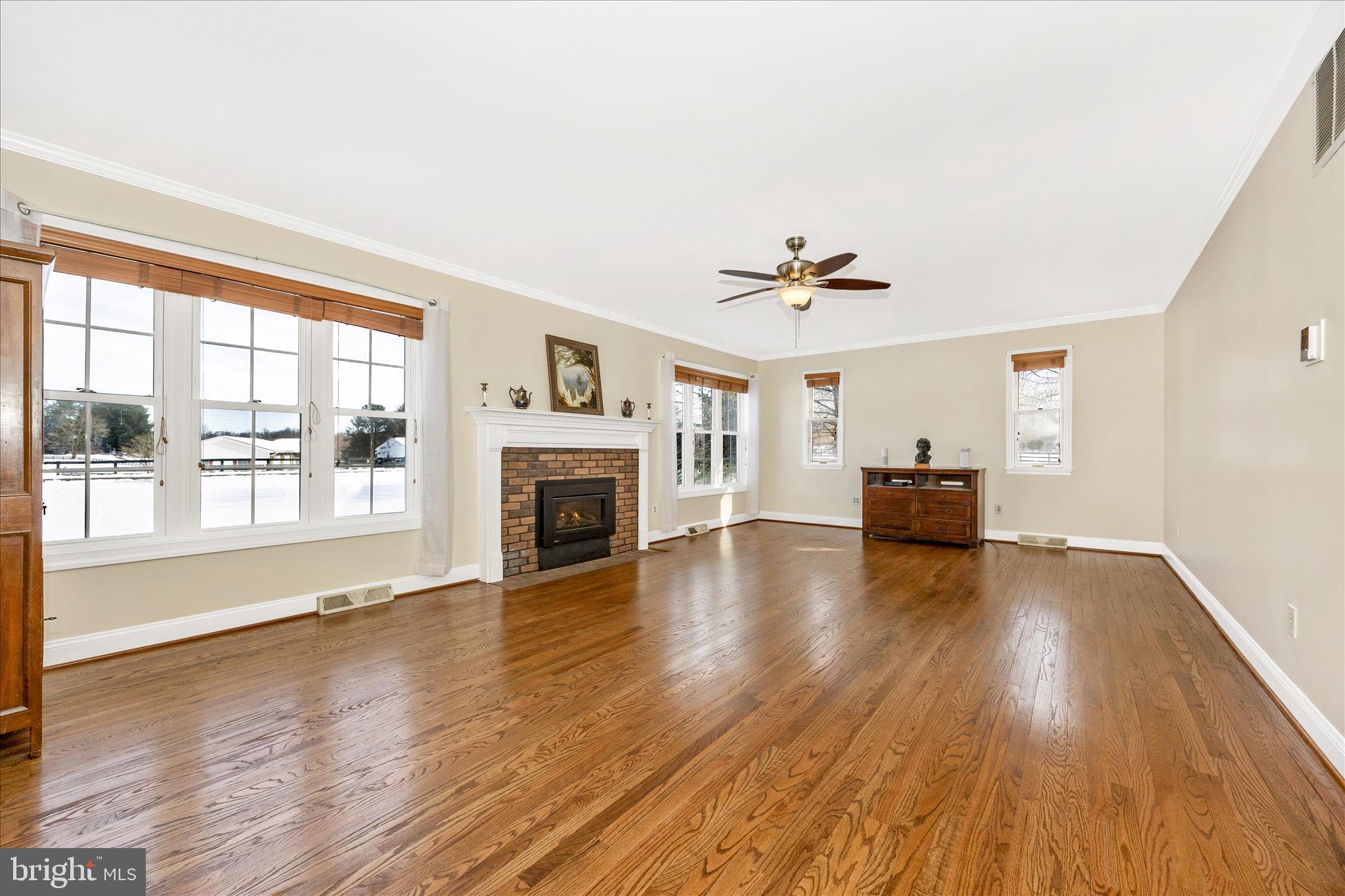 3340 Florence Road Woodbine, MD 21797 - Photo 7 of 61 a view of empty room with wooden floor and fireplace