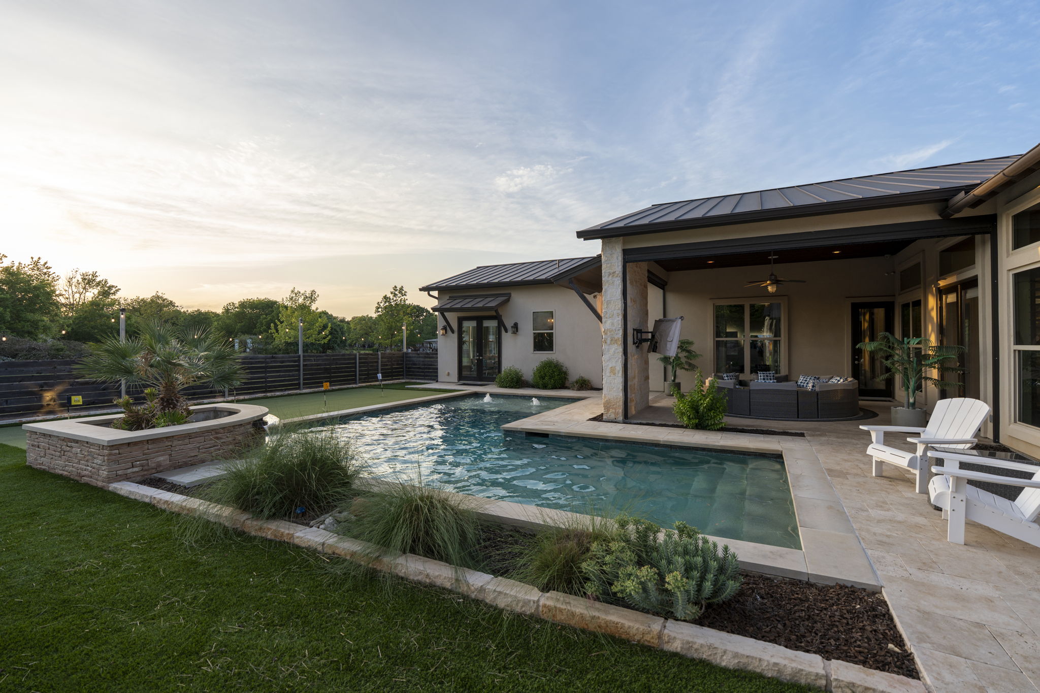 16202 Remuda Trail Buda, TX 78610 - Photo 29 of 40 The property features a swimming pool with integrated steps, surrounded by stone paving