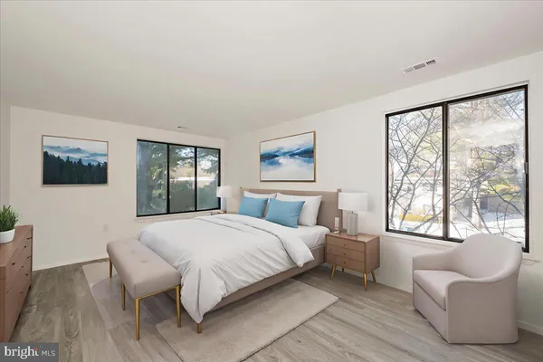 a bedroom with a large bed and a large window