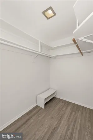 a view of a room with wooden floor and fan
