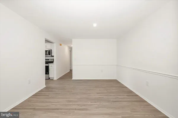 a view of a room with wooden floor