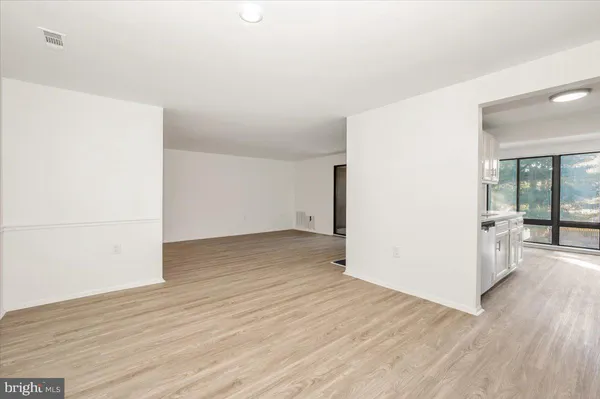 a view of a room with wooden floor